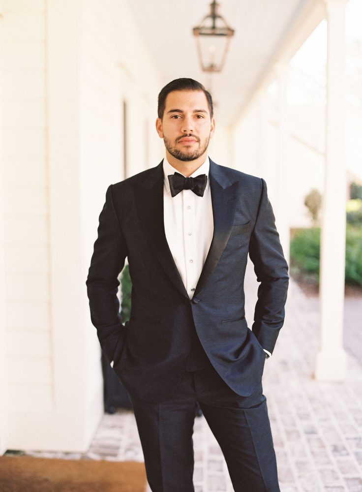 Groom wearing a black tux and bow tie