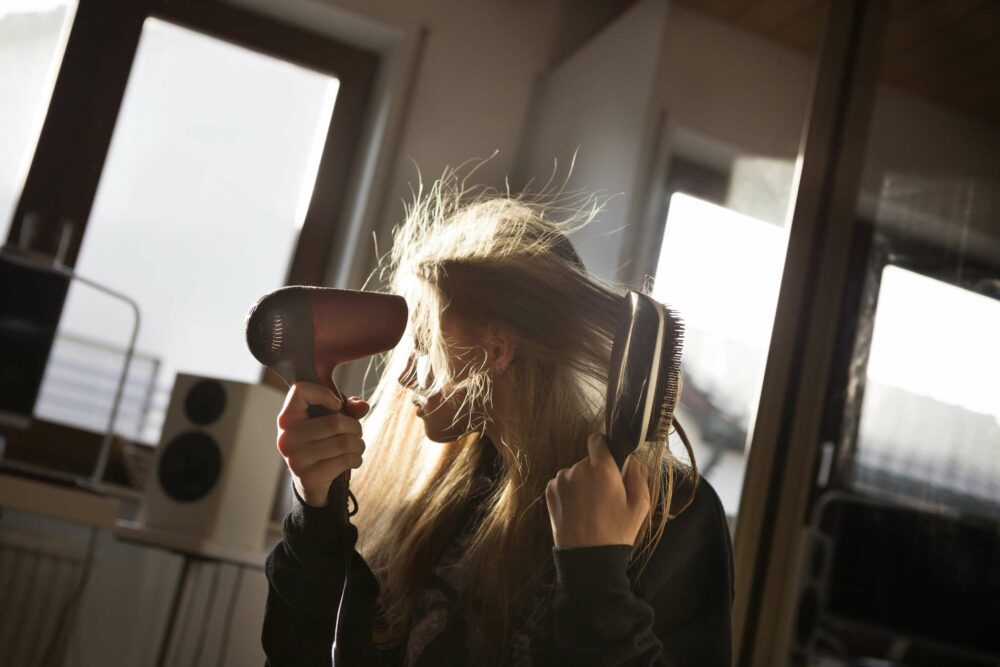 Girl styling her hair