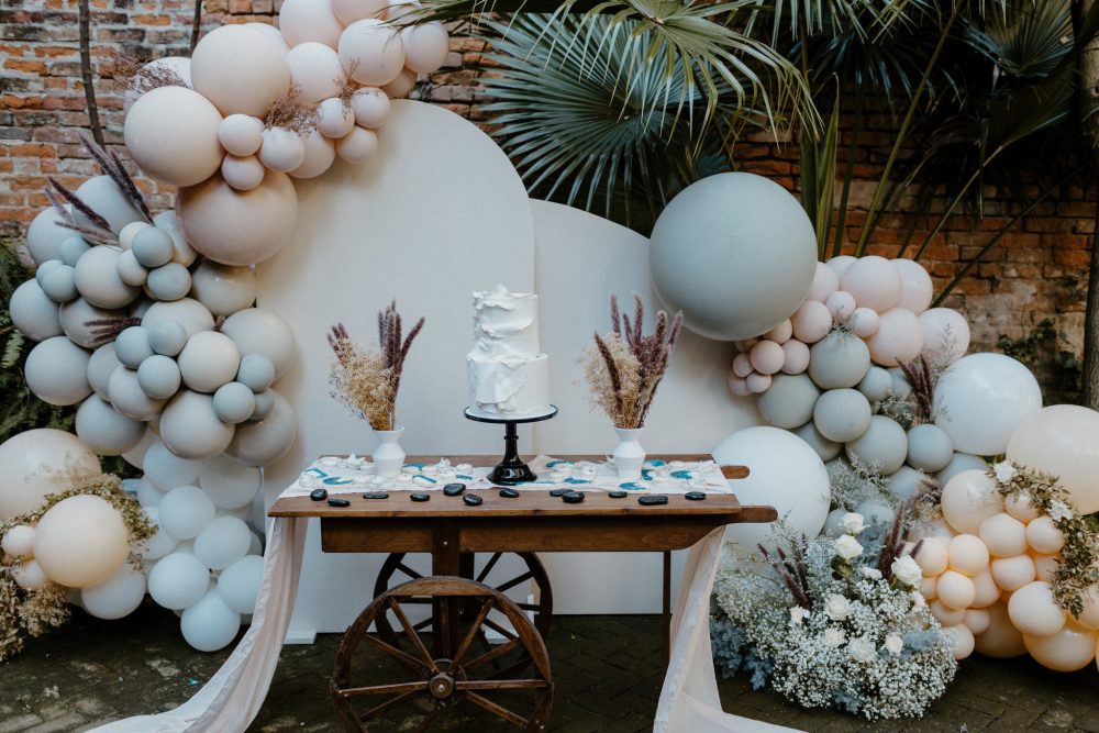 Balloons display behind the cake table