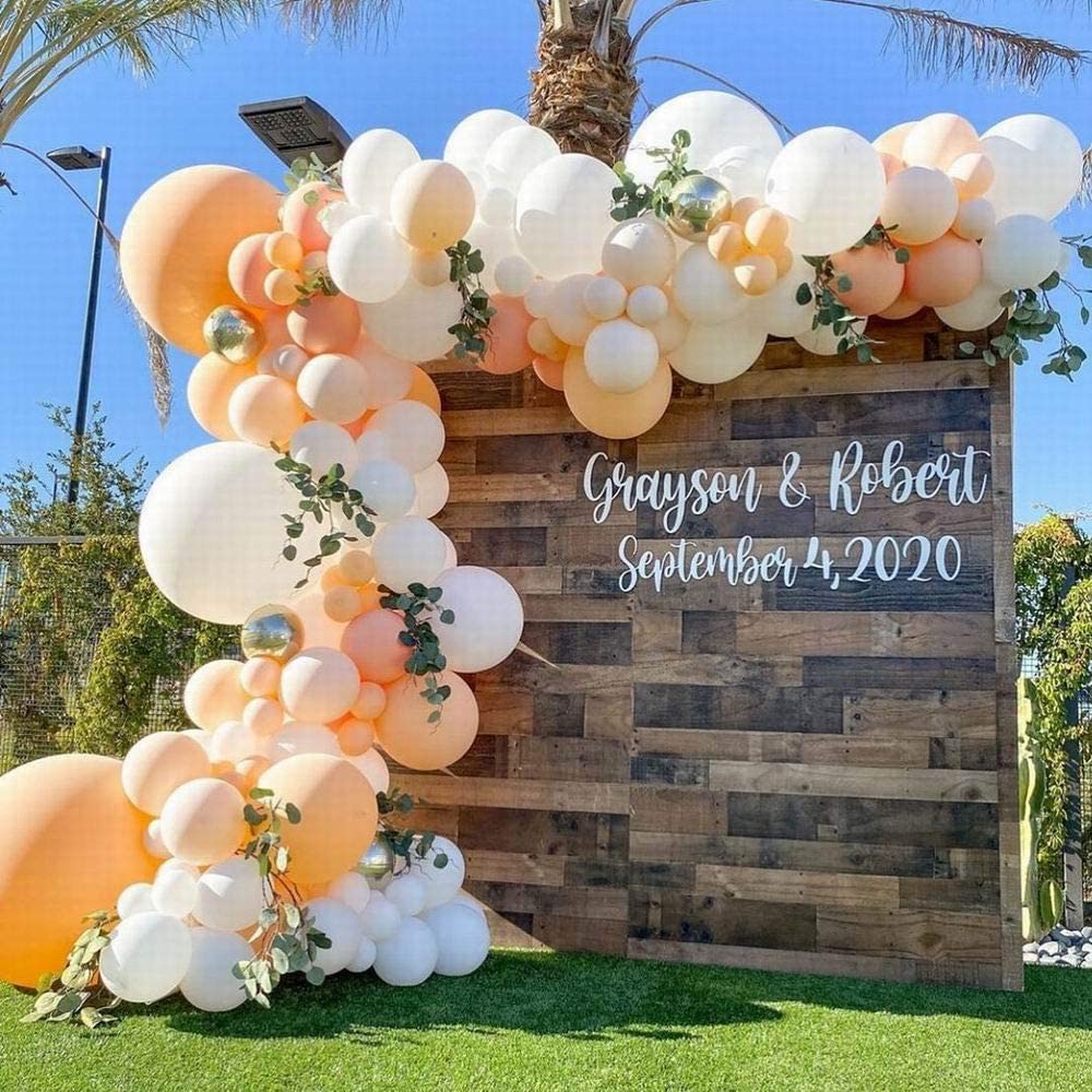 Peach and white balloon arch for a photo backdrop