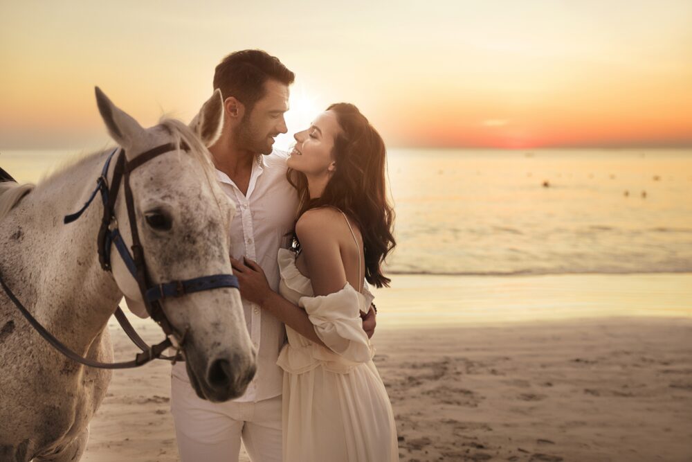 Engagement photo on the beach with a horse