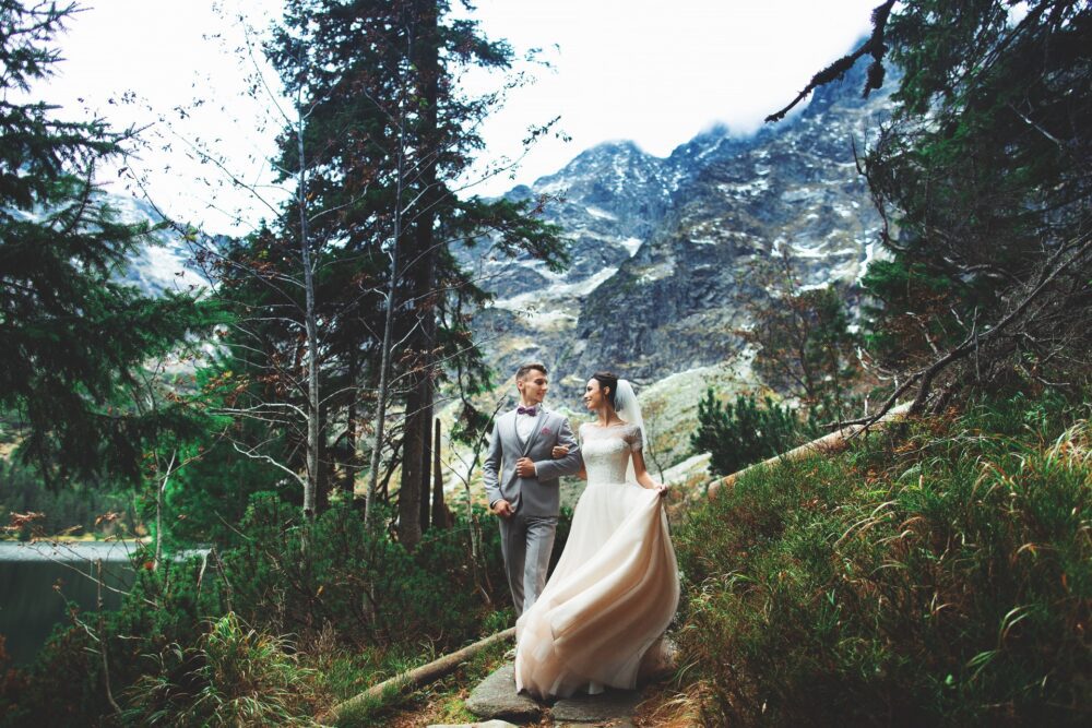 Bride and groom walking on a mountain