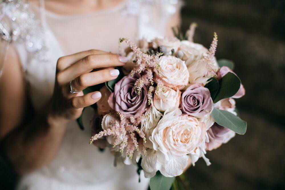 Bride holding a pale pink flower bouquet