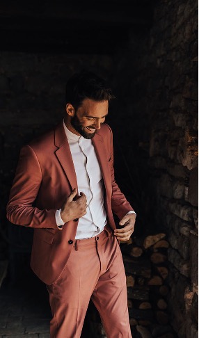 Groom wearing a coral suit
