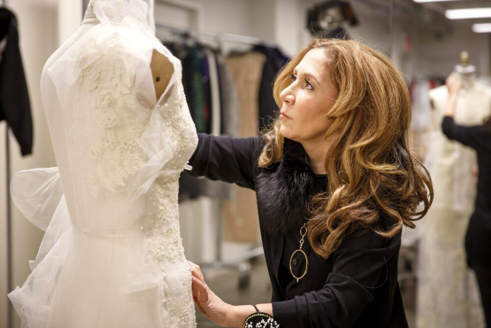 Designer Reem Acra working on a wedding dress