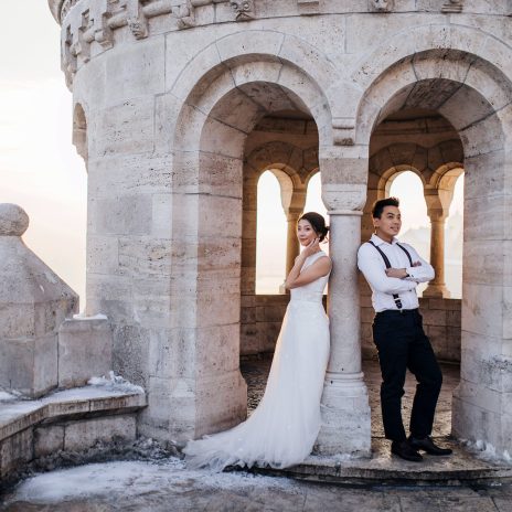Bride and groom outdoor photo in front of a castle spire