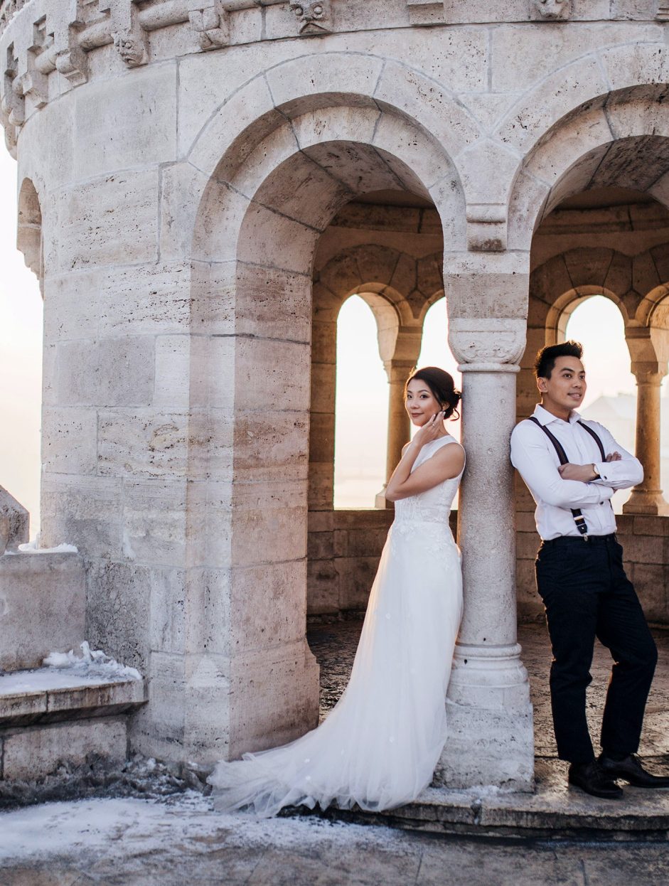 Bride and groom outdoor photo in front of a castle spire
