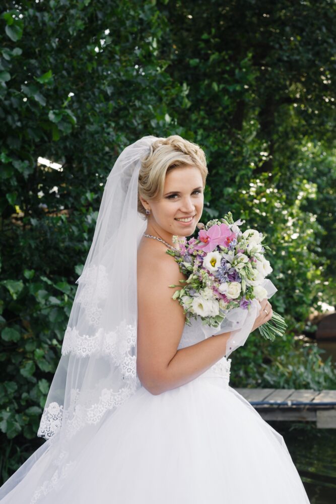 Traditional bridal portrait with a veil and bouquet
