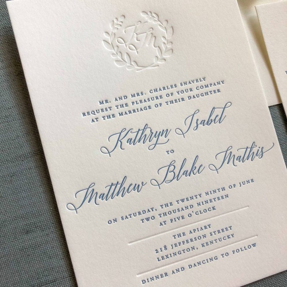 Letterpress wedding invite in dusty blue