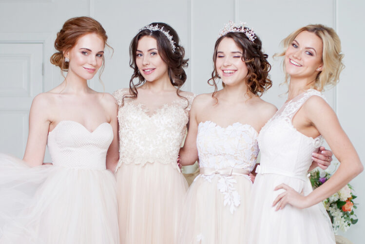 Brides wearing different shades of white wedding dresses
