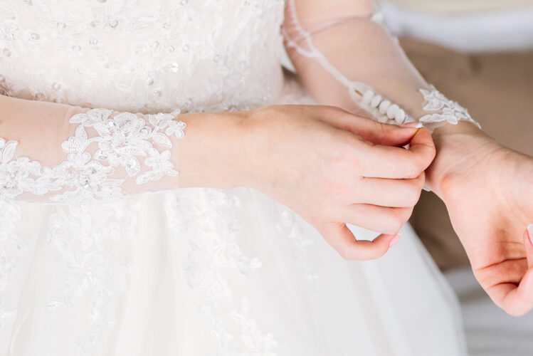 Bride Tugging on wedding dress sleeve