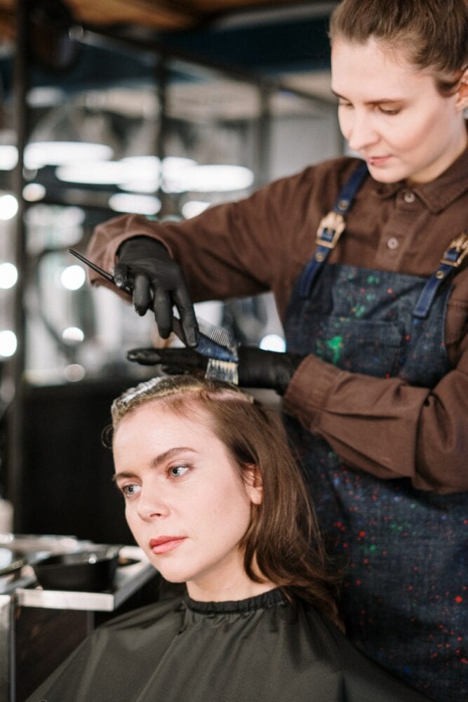 Woman getting a haircut at stylist