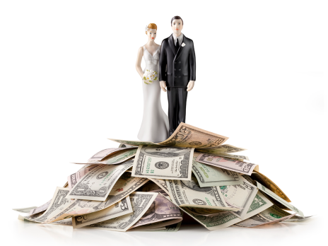 Bride and groom figurines on pile of money