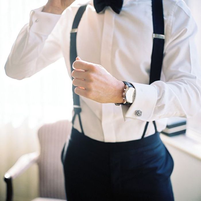 groom with watch, cufflinks, bow tie