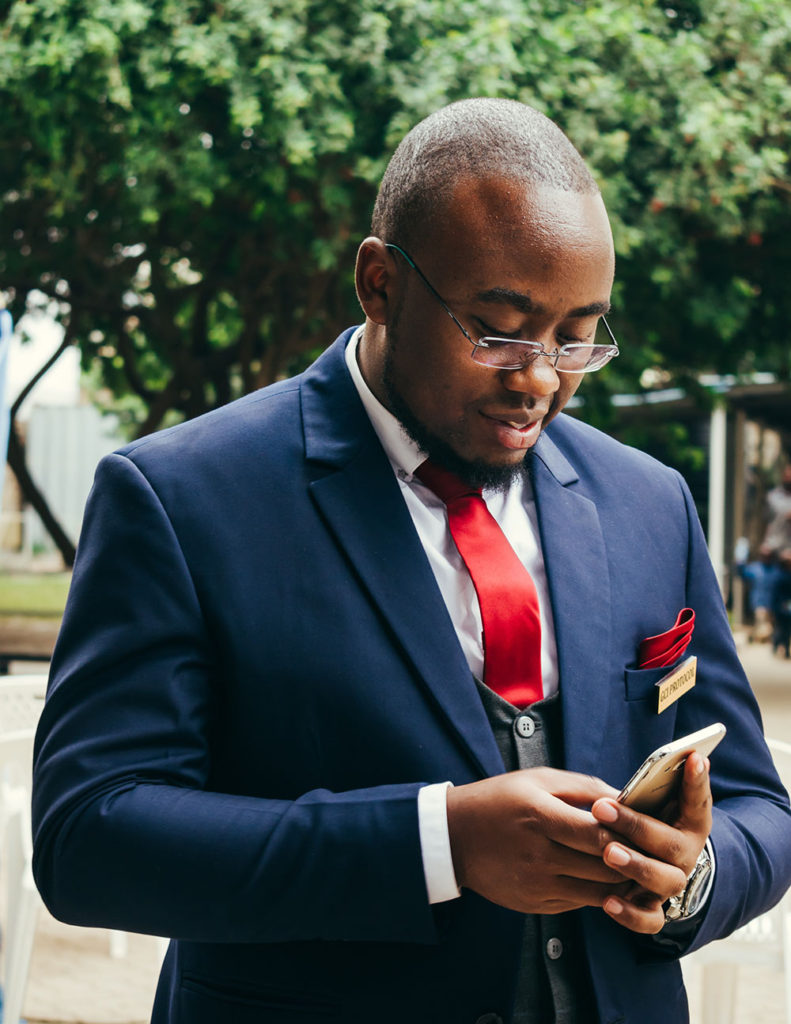 watching sports on your phone at a wedding can be avoided with these tips for setting a wedding date
