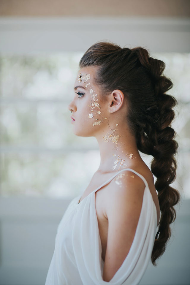 A golden Grecian bridal inspiration shoot styled with a modern braid, a simple baby's breath bouquet and small flakes of gold adorning the bride's face by Blue Rose Studio