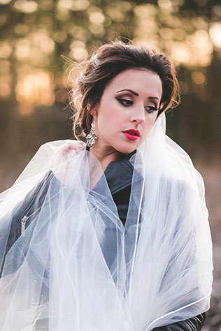 Feminine and edgy waterfall bridal portraits with a leather jacket and birdcage veil by Jessica Kait Photography