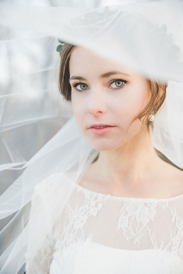 Elegant winter eucalyptus bridal portraits in Chicago by Megs Colleen with a handmade wedding gown from Cambodia