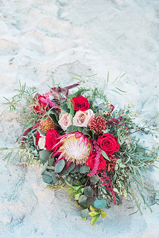A red to black bridal inspiration shoot featuring bold, dramatic wedding gowns on the beach in Hawaii by Rae Marshall Weddings