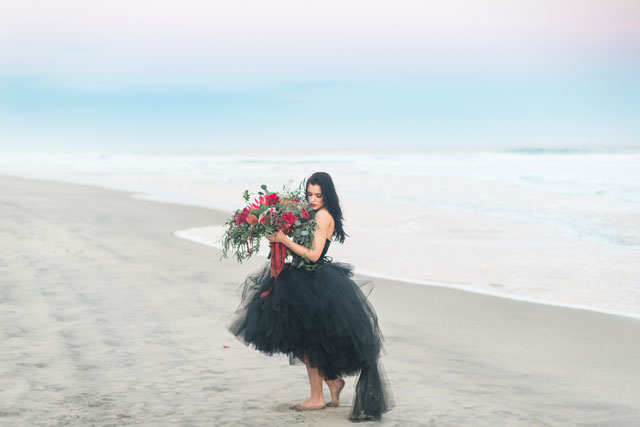 A red to black bridal inspiration shoot featuring bold, dramatic wedding gowns on the beach in Hawaii by Rae Marshall Weddings