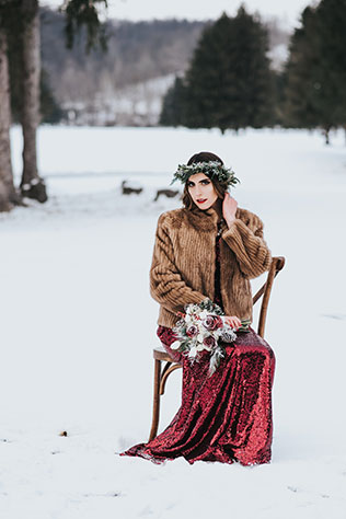 A snowy and moody winter woods styled shoot with a stunning red sequined dress by Britani Edwards Photography