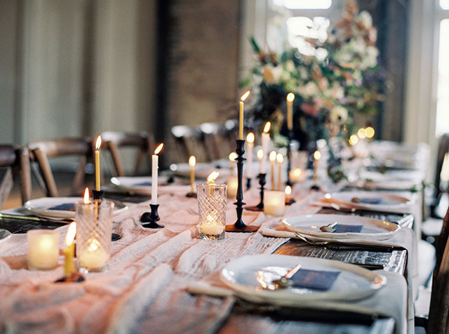 A moody winter wedding inspiration shoot filled with candlelight and exquisite black and gold details by The Ganeys