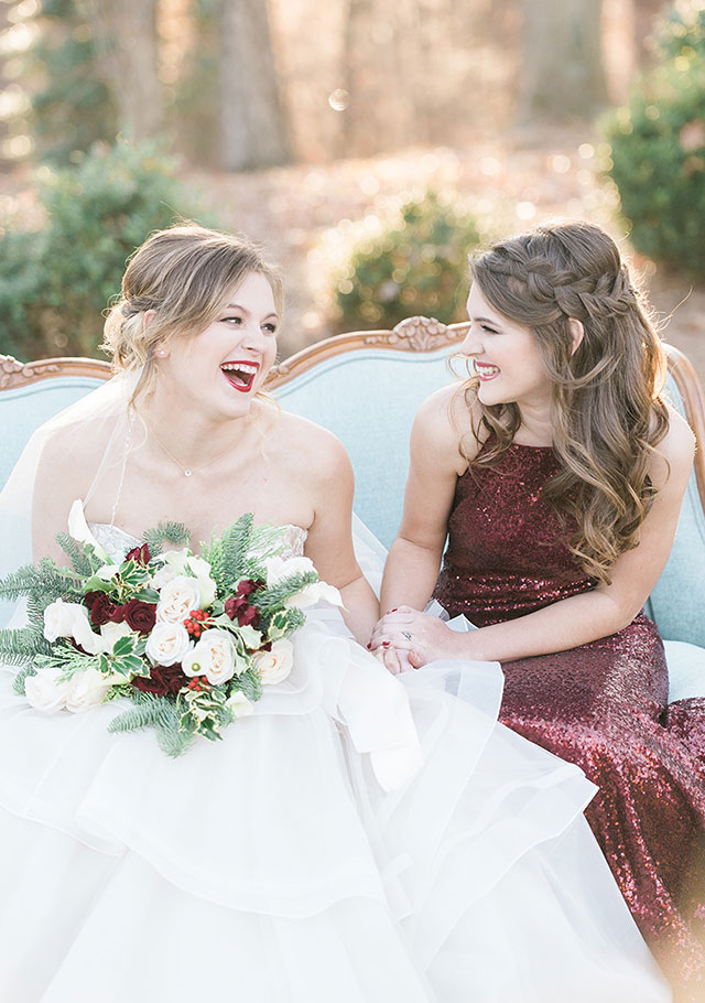 A romantic Christmas wedding inspiration shoot with a sweetheart table, cranberry cocktails, winter greenery and fur stockings by Hana Gonzalez Photography