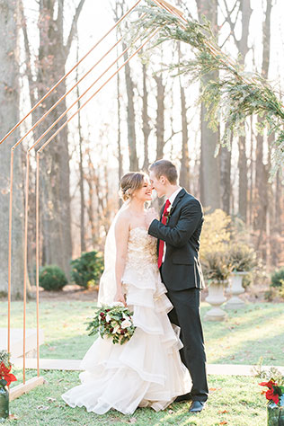 A romantic Christmas wedding inspiration shoot with a sweetheart table, cranberry cocktails, winter greenery and fur stockings by Hana Gonzalez Photography