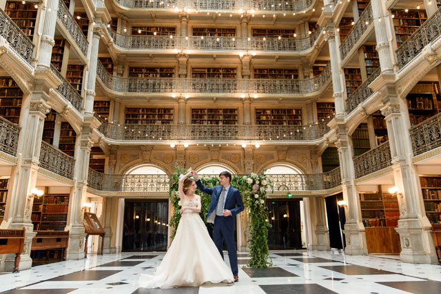 A golden, metallic library wedding inspiration shoot at the George Peabody Library with a stunning cake and floral table arch by Michelle Lynn Weddings