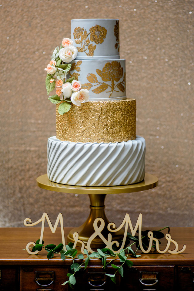 A golden, metallic library wedding inspiration shoot at the George Peabody Library with a stunning cake and floral table arch by Michelle Lynn Weddings