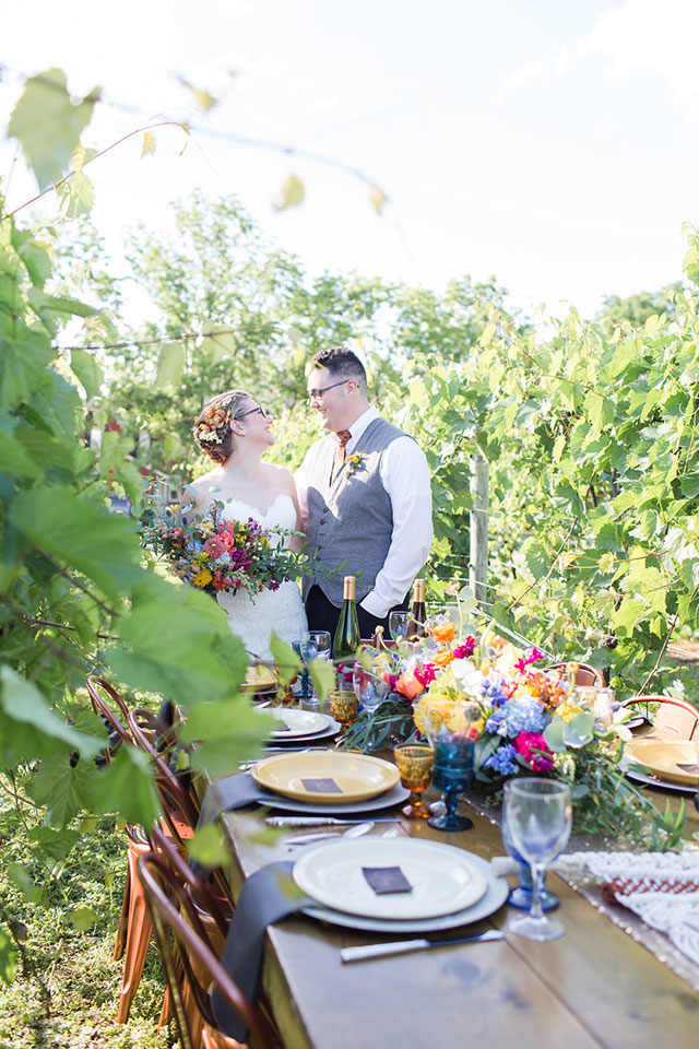 A Pennsylvania wedding styled shoot featuring a colorful table amongst the lush vines at Grovedale Winery by Seneca Ryan Co. and Forget-Me-Not Rentals