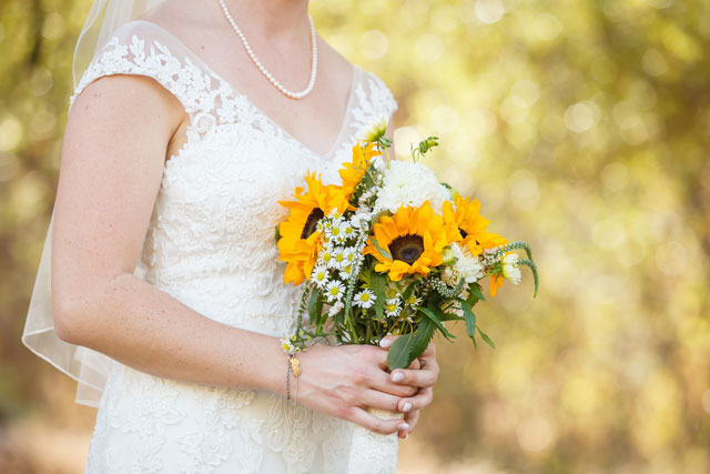 A rustic autumn River Ridge Ranch wedding with sunflowers and a fire pit by Bergreen Photography