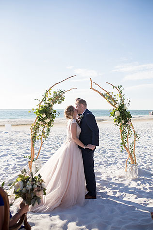 A beautiful, rustic beachside Siesta Key wedding with vintage furniture, a s'mores station and a dance floor under the stars by Cat Pennenga Photography