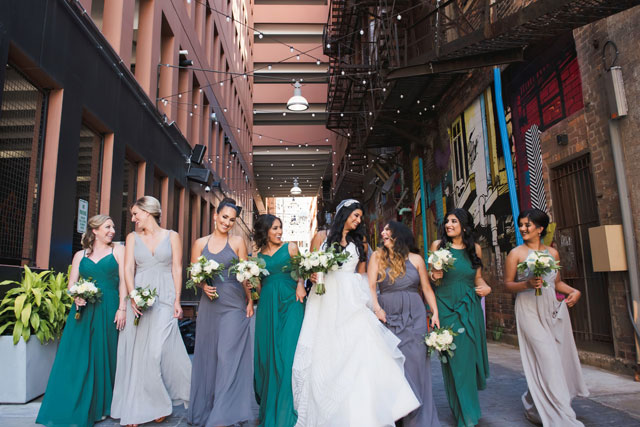 A multicultural Eastern Market wedding in Detroit with a macaron cake and a green and white color palette by E Schmidt Photography