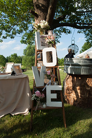 An elegant pink and white summer backyard barbecue wedding with a tented reception in Illinois by Elite Photo
