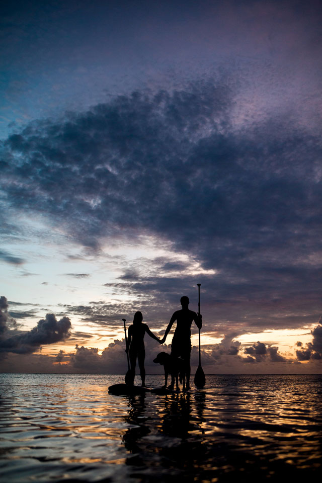 A romantic and tropical engagement session on Saipan with the couple's dog and paddle boarding by Lauren Benson Photography