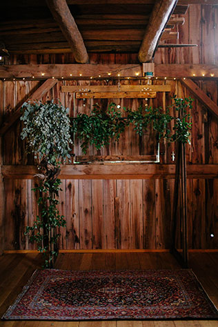 A rustic and boho chic rainy day wedding with macrame chandeliers and custom wood signage by Maiko Media and Oak & Honey Events