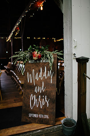 A rustic and boho chic rainy day wedding with macrame chandeliers and custom wood signage by Maiko Media and Oak & Honey Events