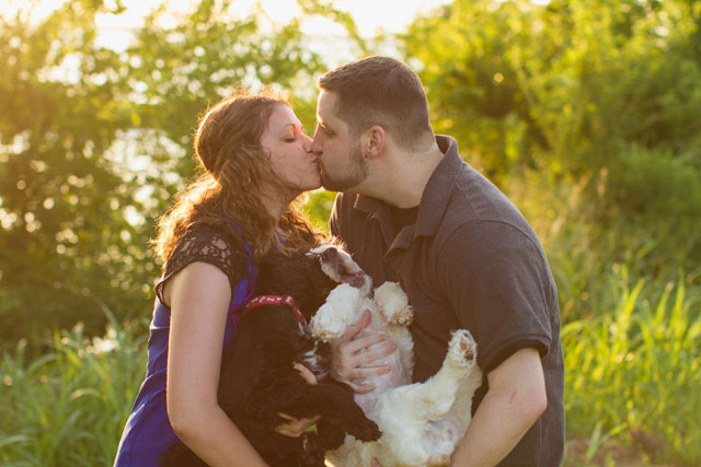 A romantic sunset lake engagement session with the couple's adorable dogs // photo by Robyn Icks Photography: http://robynicksphotography.com || see more on https://blog.nearlynewlywed.com