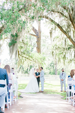 A light and airy Plantation Oaks Farm wedding with rustic details and a gorgeous purple and green palette by The Copper Lens Photography Co.